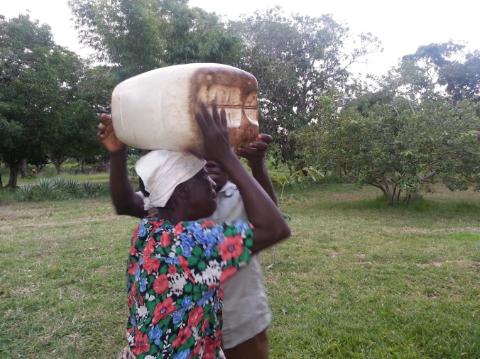 They still have to carry it home, though the distance is not so far. Even so, 20 liters of water on the head is no easy task.